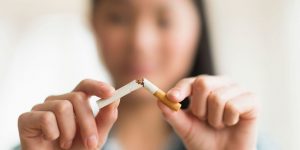 A quitting smoker with a broken cigarette