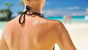 Spf 30 sunscreen on the girl's back