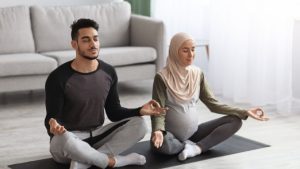 pregnant muslim woman doing yoga