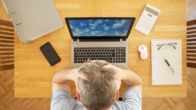 Stressed man sitting - Mental Health Benefits of Working Remotely