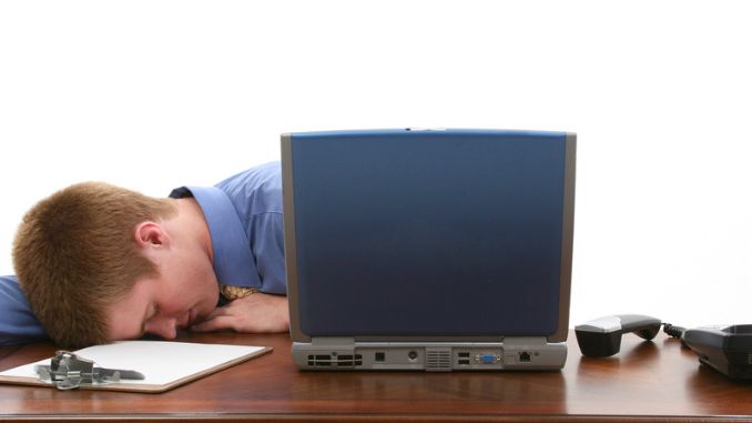 Young Man Asleep at Desk - Mental Health Benefits of Working Remotely